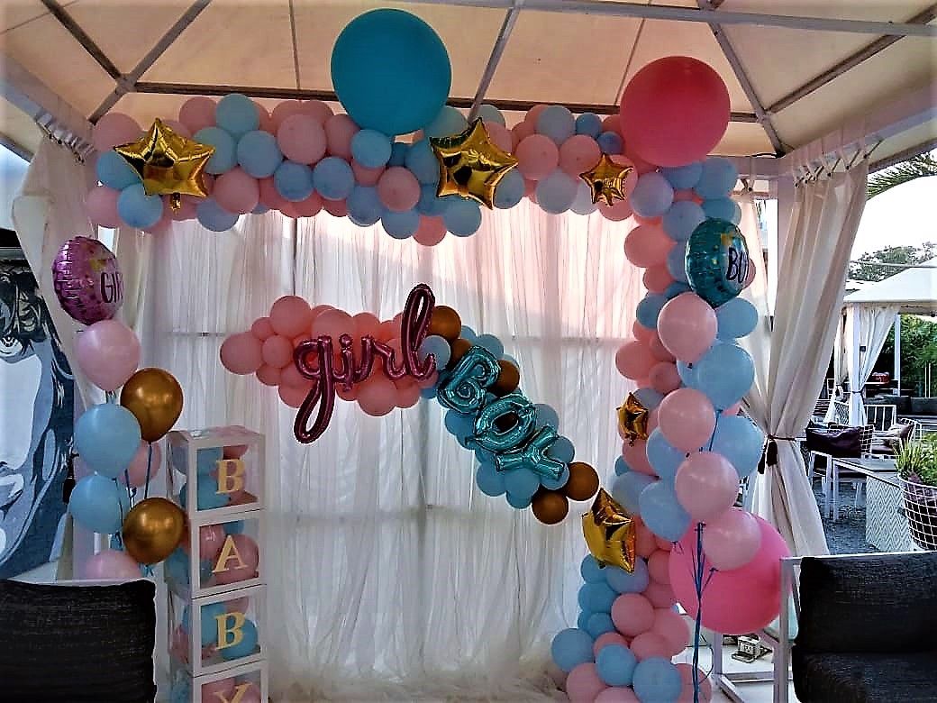 White cloth backdrop with pastel balloons arch and bunches with foils