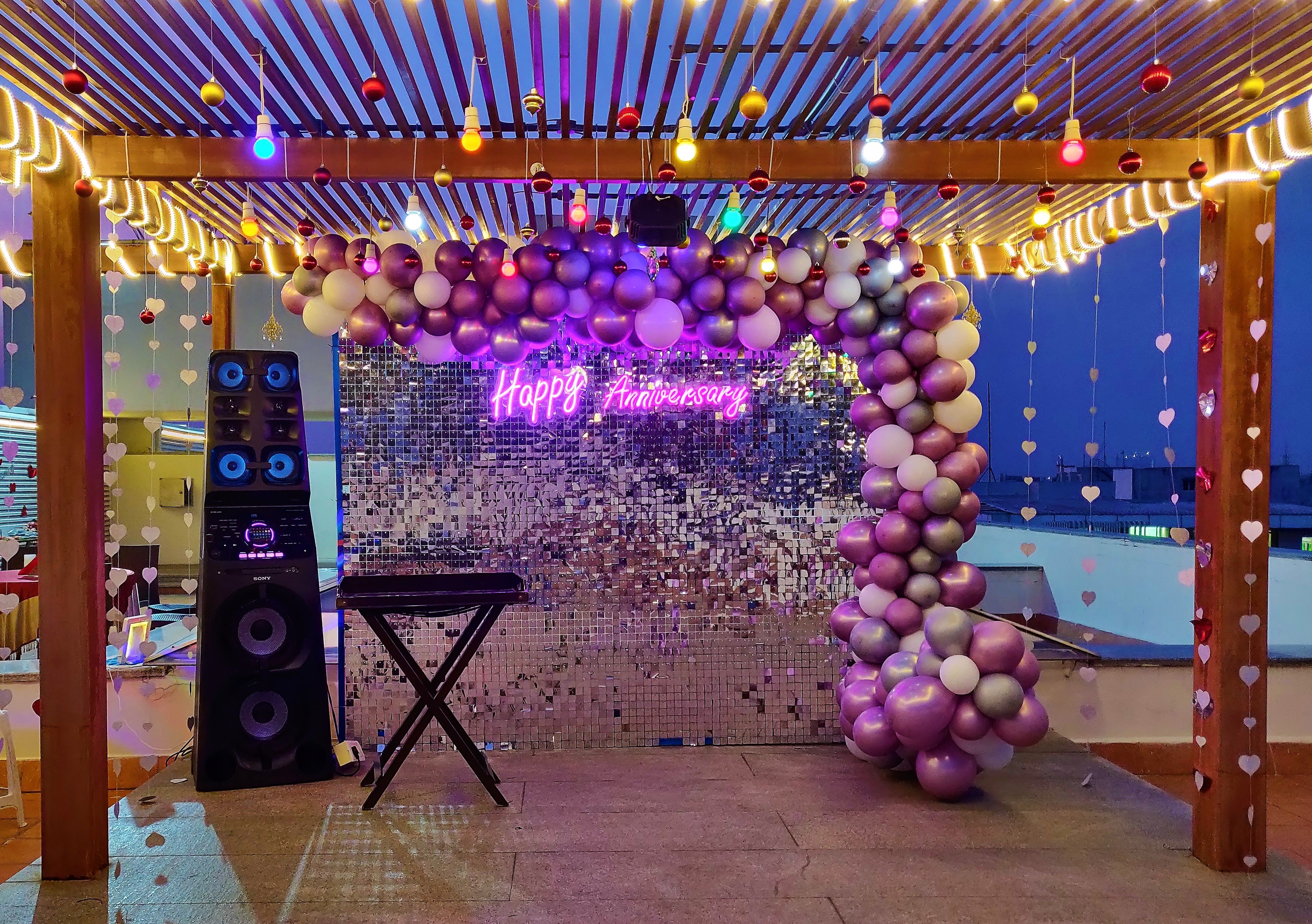 Silver glitter backdrop with lavender shades balloon arch