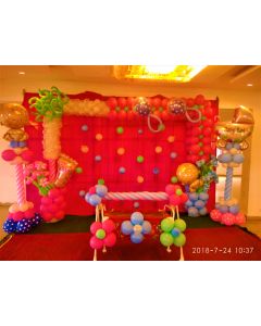 Cloth backdrop with balloon arrangement including columns